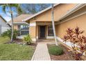 Inviting front entryway with brick pathway, lush landscaping, and a stylish front door at 4069 102Nd N Pl, Clearwater, FL 33762