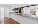 Bright kitchen featuring granite countertops, stainless steel appliances, and wood floors at 4069 102Nd N Pl, Clearwater, FL 33762