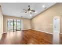 Bright and airy living room featuring wood floors, ceiling fan, and sliding door access at 4069 102Nd N Pl, Clearwater, FL 33762