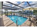 Private screened pool with clear water, a patio, and views of the canal at 5024 Cedarbrook Ln, Hernando Beach, FL 34607