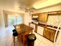 Bright kitchen featuring an island, tile floors, and sliding glass doors to the backyard at 5603 Sycamore N St # 5603, St Petersburg, FL 33703