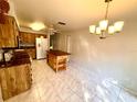 Open concept kitchen with a kitchen island, tile floors and updated lighting at 5603 Sycamore N St # 5603, St Petersburg, FL 33703