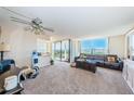 Bright living room with large windows offering scenic water views and comfortable seating at 6210 Sun Blvd # 408, St Petersburg, FL 33715