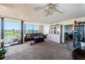 Spacious living room with glass doors and a view of the golf course at 6210 Sun Blvd # 408, St Petersburg, FL 33715