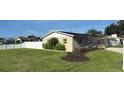 Spacious backyard with green grass and a white vinyl fence for privacy at 6310 57Th N Ave, St Petersburg, FL 33709