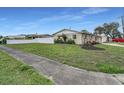 Well-manicured lawn surrounding a single-story home with a privacy fence at 6310 57Th N Ave, St Petersburg, FL 33709