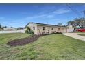 Well-kept house with green lawns, a garden bed, and a white fence for added curb appeal and privacy at 6310 57Th N Ave, St Petersburg, FL 33709