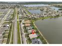 Aerial view showcases the property's location near a lake and the surrounding community, with street views at 827 Seminole Sky Dr, Ruskin, FL 33570