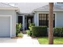 Inviting front exterior with well-manicured landscaping leading to a beautiful glass front door at 992 San Carlos Ne Ct, St Petersburg, FL 33702
