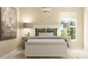 Cozy bedroom featuring a bead-board bed, elegant chandelier, neutral color palette, and soft natural light at 106 Lilyan Ct, Rotonda West, FL 33947