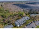 Aerial view showcasing community amidst a backdrop of serene wooded surroundings at 1182 Pine Ridge W Cir # B1, Tarpon Springs, FL 34688