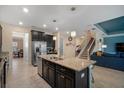 Spacious kitchen with a large center island, stainless steel appliances, and open floor plan at 11965 Cinnamon Fern Dr, Riverview, FL 33579