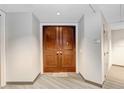 A condo entryway with double wood doors and a mat that says 'Be Our Guest' at 1209 E Cumberland Ave # 1703, Tampa, FL 33602