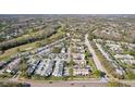 An aerial view of a townhome community with landscaping, parking and easy access to main roads at 16143 Rambling Vine E Dr, Tampa, FL 33624