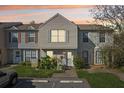 Charming two-story townhouse featuring neutral siding and a well-manicured front yard with lush landscaping at 16143 Rambling Vine E Dr, Tampa, FL 33624