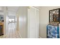Inviting hallway with tile flooring, coat closet and access to the main living areas of the home at 16143 Rambling Vine E Dr, Tampa, FL 33624