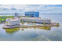 Beautiful aerial view of waterfront condo community featuring a pool, landscaping, and ocean views at 2506 N Rocky Point Dr # 358, Tampa, FL 33607