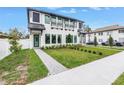 Charming new construction featuring a modern design, manicured lawn, and a stylish black front door at 2810 N Massachusetts Ave, Tampa, FL 33602