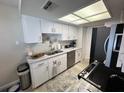 Efficient kitchen with stainless steel appliances, bright lighting, and ample cabinet space at 3497 Birchwood Ct, Palm Harbor, FL 34684