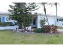 Inviting single-story home with well-manicured landscaping around the house and beautiful flower beds in the front yard at 3710 98Th N Ave, Pinellas Park, FL 33782