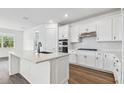 Modern kitchen featuring an island, stainless steel appliances, and white cabinetry at 37252 Clinch Cir, Zephyrhills, FL 33540