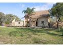 View of the home's exterior with lawn, landscaping, and neutral color palette at 404 Craft Rd, Brandon, FL 33511