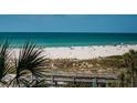 Picturesque beach scene with people enjoying the sun and surf, a beautiful view at 4450 Gulf Blvd # 303, St Pete Beach, FL 33706