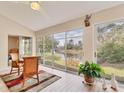 Bright sunroom featuring scenic water views, lots of sunlight, with a ceiling fan, tile floors, and a lovely rug at 4579 Del Sol S Blvd, Sarasota, FL 34243
