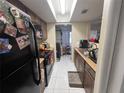 Practical kitchen featuring tile floors and plenty of counter space at 5034 Terrace Village Ln, Tampa, FL 33617