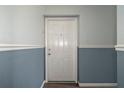 A secure front door featuring neutral paint tones and decorative molding, offering a secure and welcoming entry at 5075 Starfish Se Dr # B, St Petersburg, FL 33705