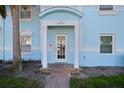 Charming front entrance with a covered porch, brick pathway, and well-manicured landscaping and a glimpse of the unit's address at 5075 Starfish Se Dr # B, St Petersburg, FL 33705