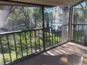 A screened in balcony with a view of green space and mature trees at 700 Starkey Rd # 1525, Largo, FL 33771