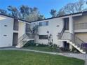 Charming condo building offers exterior staircases leading to upper level units with well-maintained landscaping at 700 Starkey Rd # 1525, Largo, FL 33771