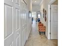 Well-lit hallway featuring decorative molding, tile floors and stylish decor at 7305 River Hammock Dr # 204, Bradenton, FL 34212