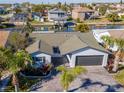 Single-Gathering home with well-maintained landscaping, attached garage, and waterfront access at 7309 Islander Ln, Hudson, FL 34667
