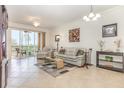 Bright living room with tile floors, neutral tones, comfortable seating, and a screened lanai at 8403 Grand Estuary Trl # 204, Bradenton, FL 34212