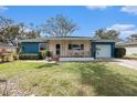Charming home with a cozy front porch perfect for relaxing and enjoying the neighborhood at 908 Woodley Rd, Clearwater, FL 33764