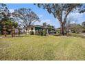 Expansive yard featuring mature trees, tasteful landscaping, and plenty of room to roam at 908 Woodley Rd, Clearwater, FL 33764
