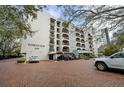 Exterior shot of condo building featuring a red brick parking area and well-maintained landscaping at 105 4Th Ne Ave # 405, St Petersburg, FL 33701