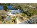 An aerial view of a charming single-Gathering home, showcasing the property's landscaping and lake access at 1131 60Th Ave S, St Petersburg, FL 33705