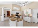 Bright kitchen featuring white cabinets, granite countertops, stainless steel appliances, and a breakfast bar at 182 Rotonda N Blvd, Rotonda West, FL 33947