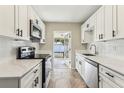 Updated kitchen featuring white cabinets, stainless steel appliances, and a view to the back patio at 1839 Ridgeway Dr, Clearwater, FL 33755