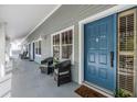 Hallway view with seating and a blue front door with the number 304 at 2511 Dolly Bay Dr # 304, Palm Harbor, FL 34684