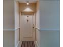 Front door of condo #203 features neutral paint, a peephole, and new hardware at 30 Turner St # 203, Clearwater, FL 33756