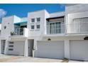 Stylish townhomes with private balconies, garages, and contemporary white facades at 3101 W El Prado Blvd # B, Tampa, FL 33629