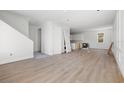 Open-concept living area with hardwood floors, white walls, and a view of the kitchen area at 3207 N Florida Ave # 1, Tampa, FL 33603