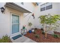 Close-up of the front entrance featuring a storm door and well-maintained garden at 3280 39Th S St # B, St Petersburg, FL 33711