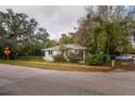 Charming exterior view of home with mature landscaping in a quiet neighborhood at 3425 E Powhatan Ave, Tampa, FL 33610