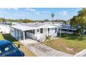 Cozy one-story home showcasing carport and small front porch at 35145 Garber Ln, Zephyrhills, FL 33541