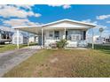 Single story home with covered parking and small front porch at 35145 Garber Ln, Zephyrhills, FL 33541